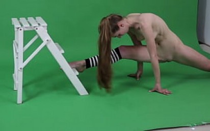 Young brunette gymnast Anna Mostik spreading legs